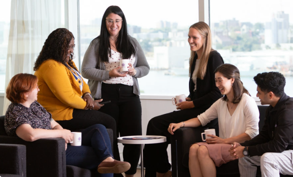 BOYNECLARKE colleagues talk together in a lounge area over coffee.